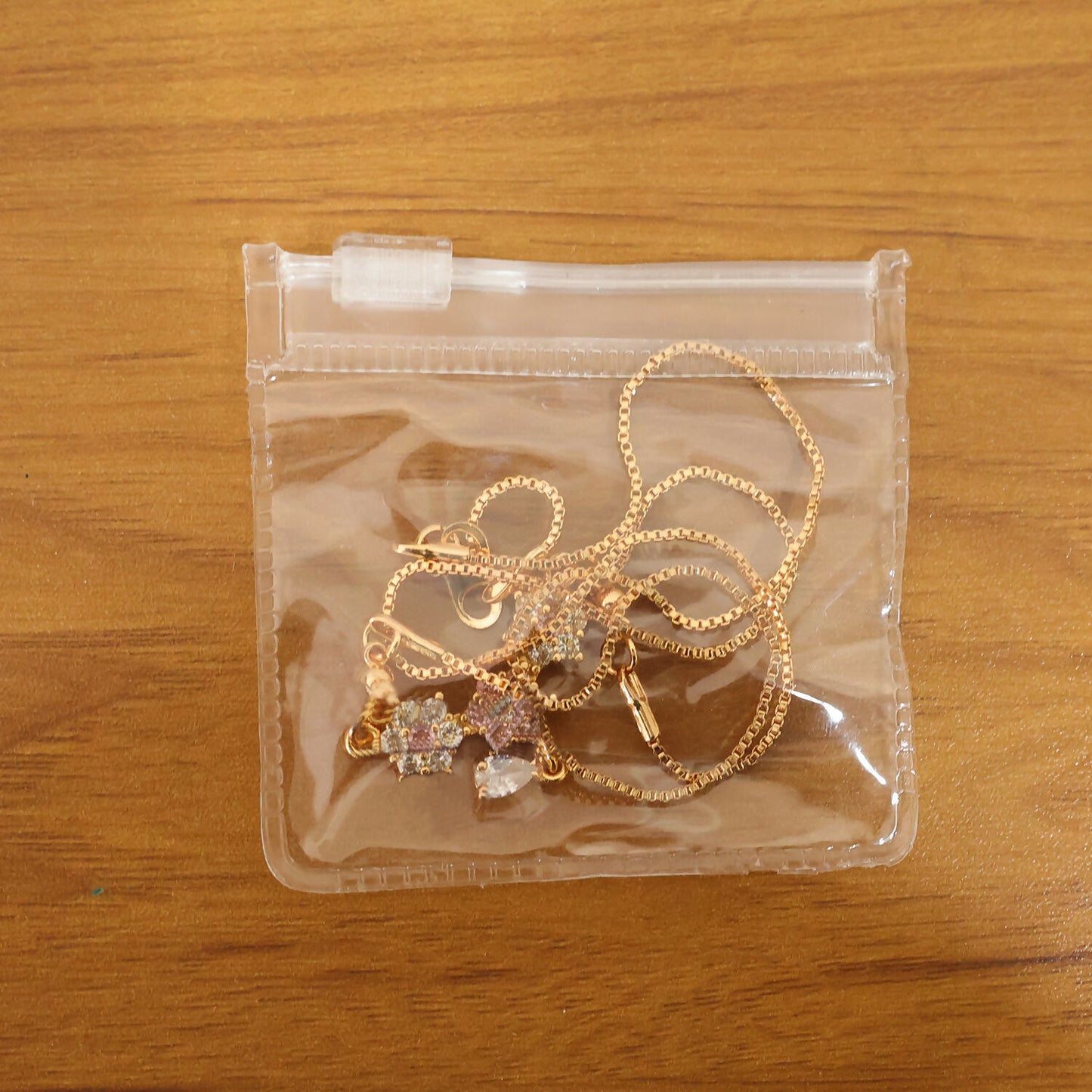 Styled image of gold finish floral stone necklace worn to highlight neckline