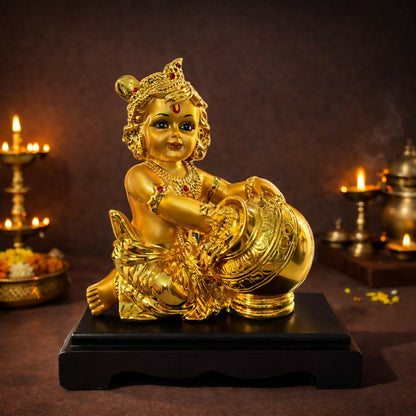 Close-up of Bal Krishna idol Butter pot statue golden finish