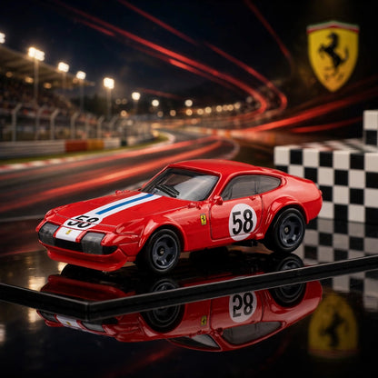 A red Hot Wheels Ferrari with racing stripes and number 58 on the side, displayed on a reflective surface with a blurred