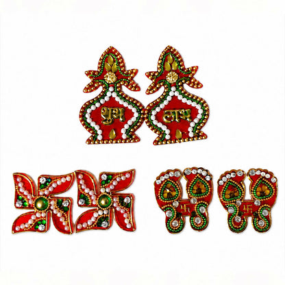 A full set of red and gold Shubh Labh kalash, Swastik, and Laxmi Charan Paduka stickers with green and white accents on a