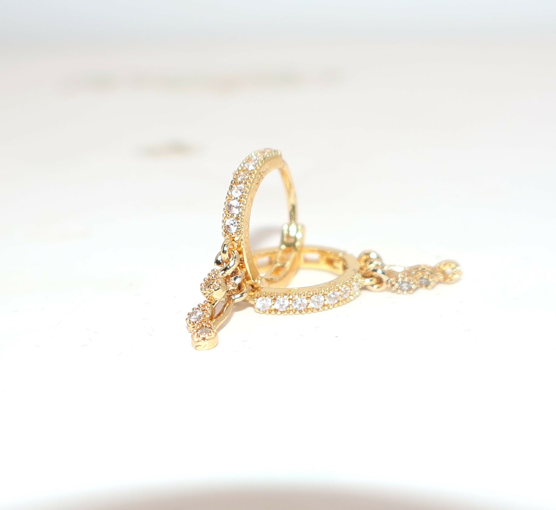 Silver-toned dainty butterfly stud earrings featuring a clear central stone