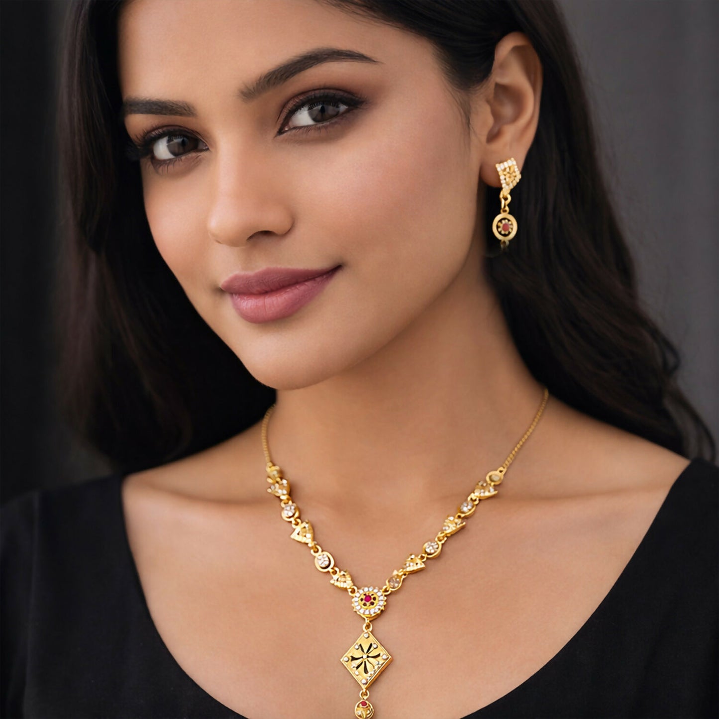 Close-up of intricate design and sparkling stones on gold-plated necklace set