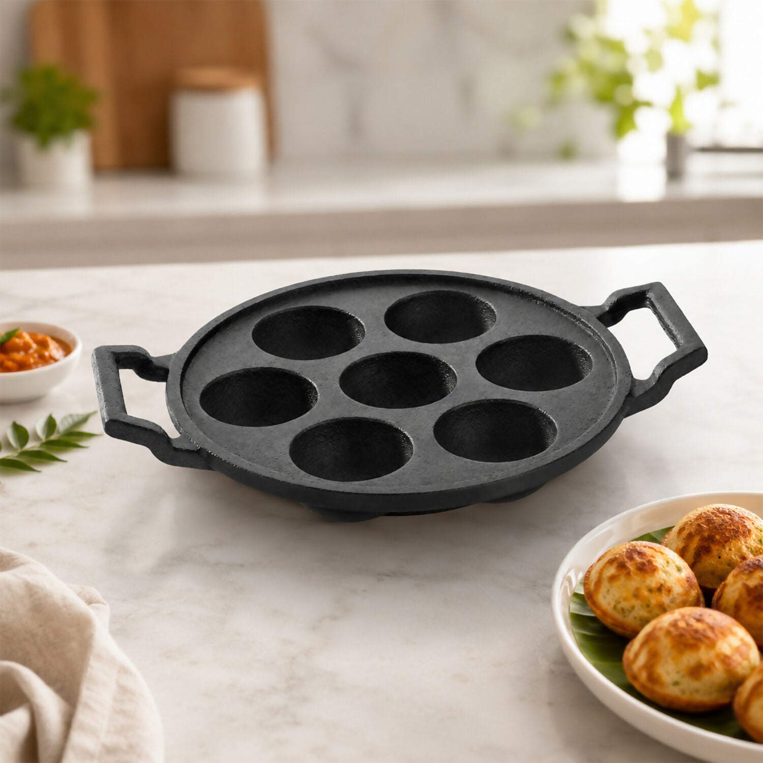 Close-up of 7 cavities in cast iron appam pan