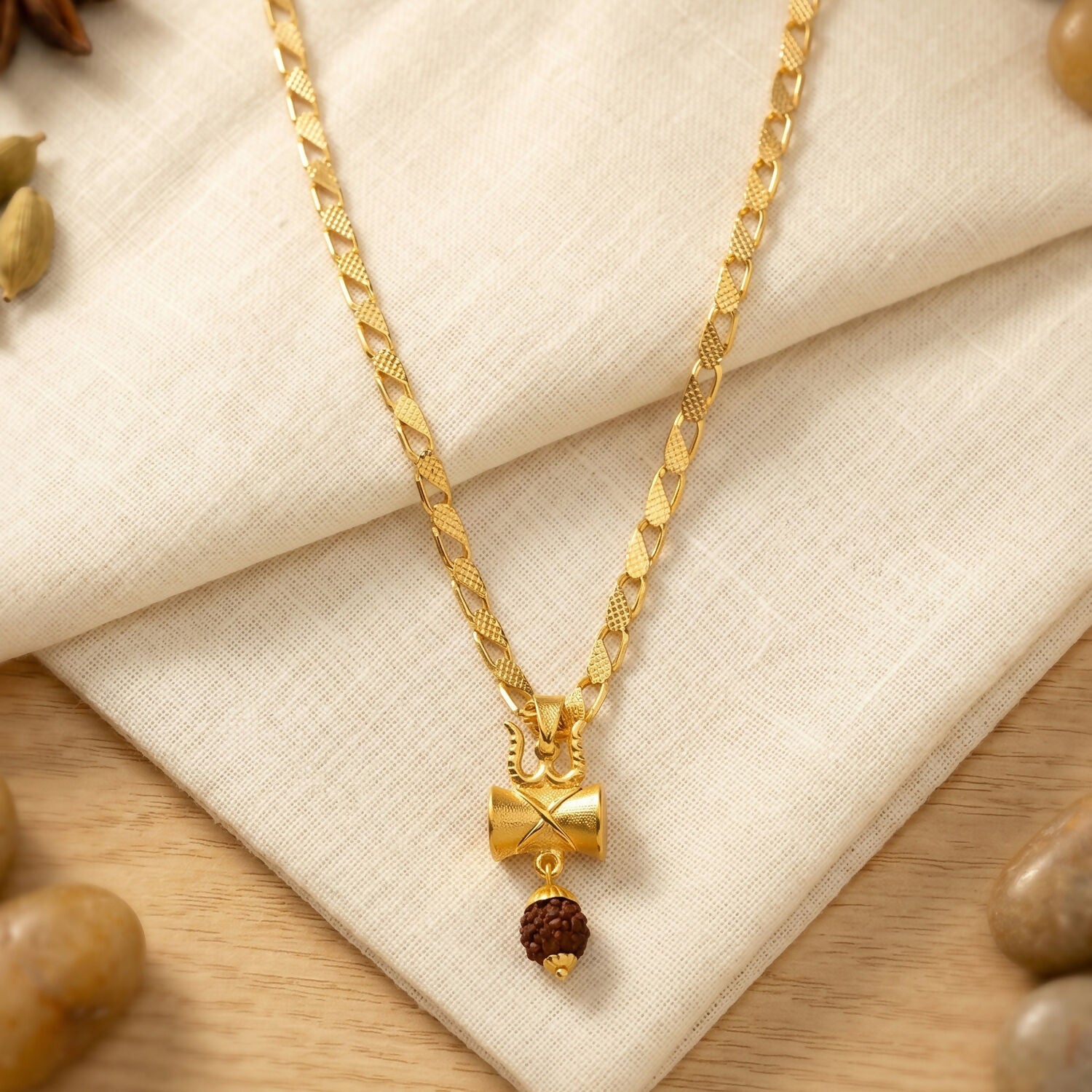 Close-up of the gold finish Rudraksha Damru Trishul necklace