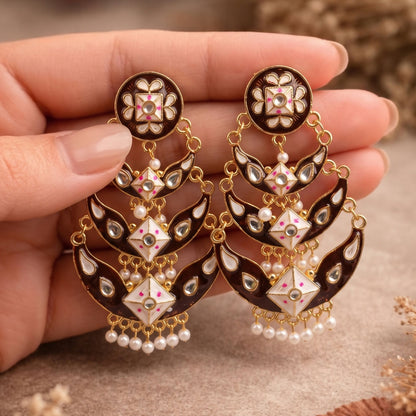 Close-up of black meenakari pattern and decorative stones in earring