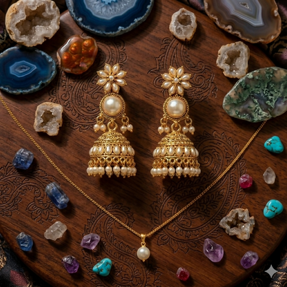 Close-up of pearl drops and black stones on oxidised jhumka earrings