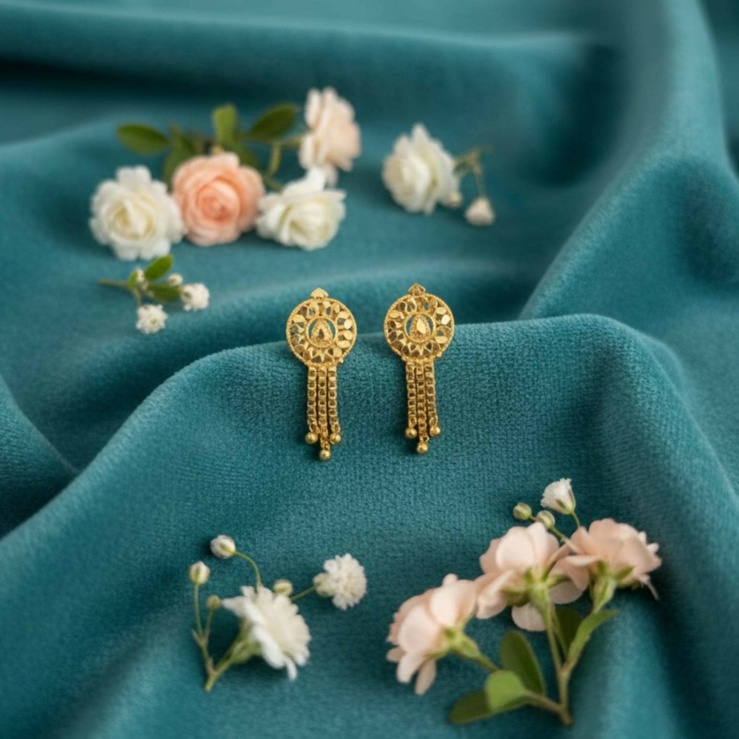 Golden jhumka earrings with intricate filigree and colorful enamel accents