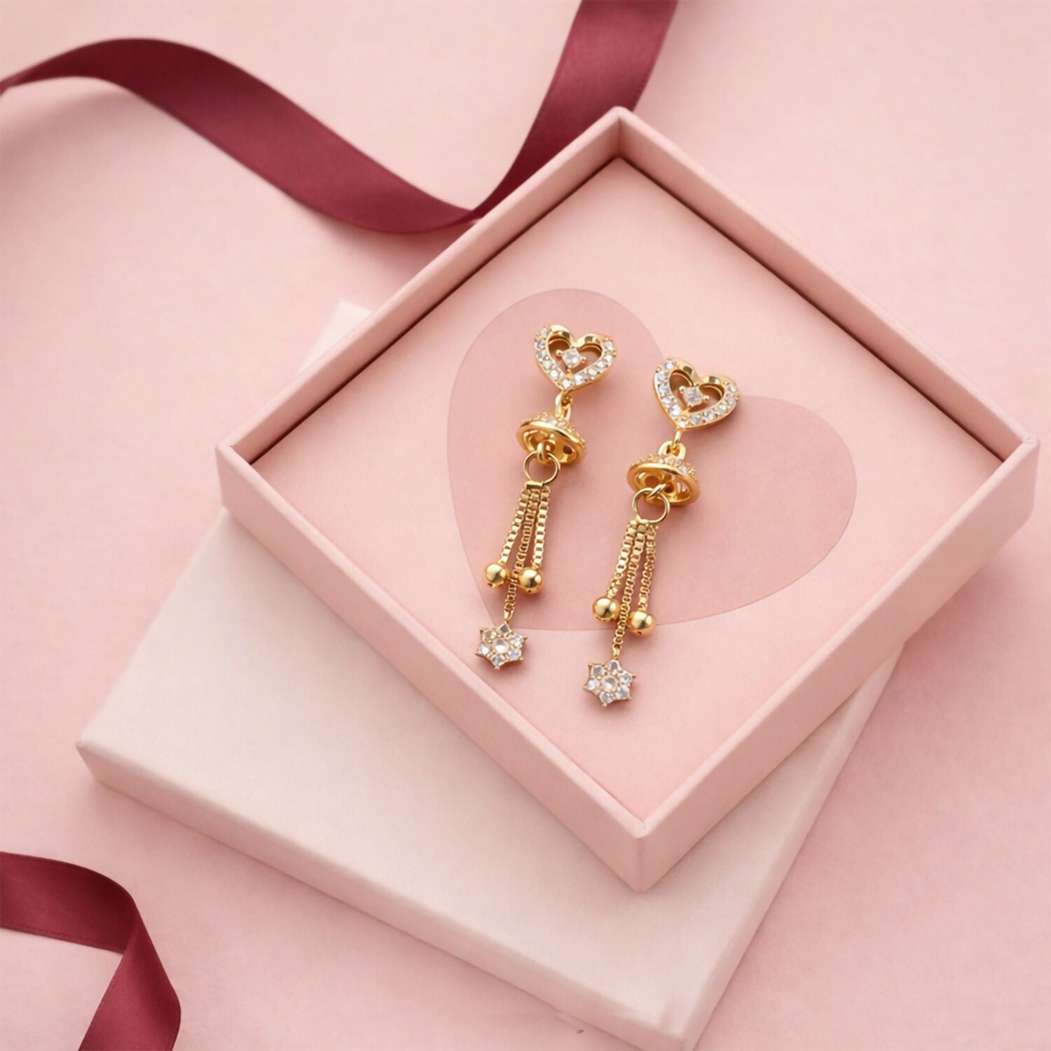 Double heart crystal drop earrings with dome-shaped detail and star-shaped crystal charm