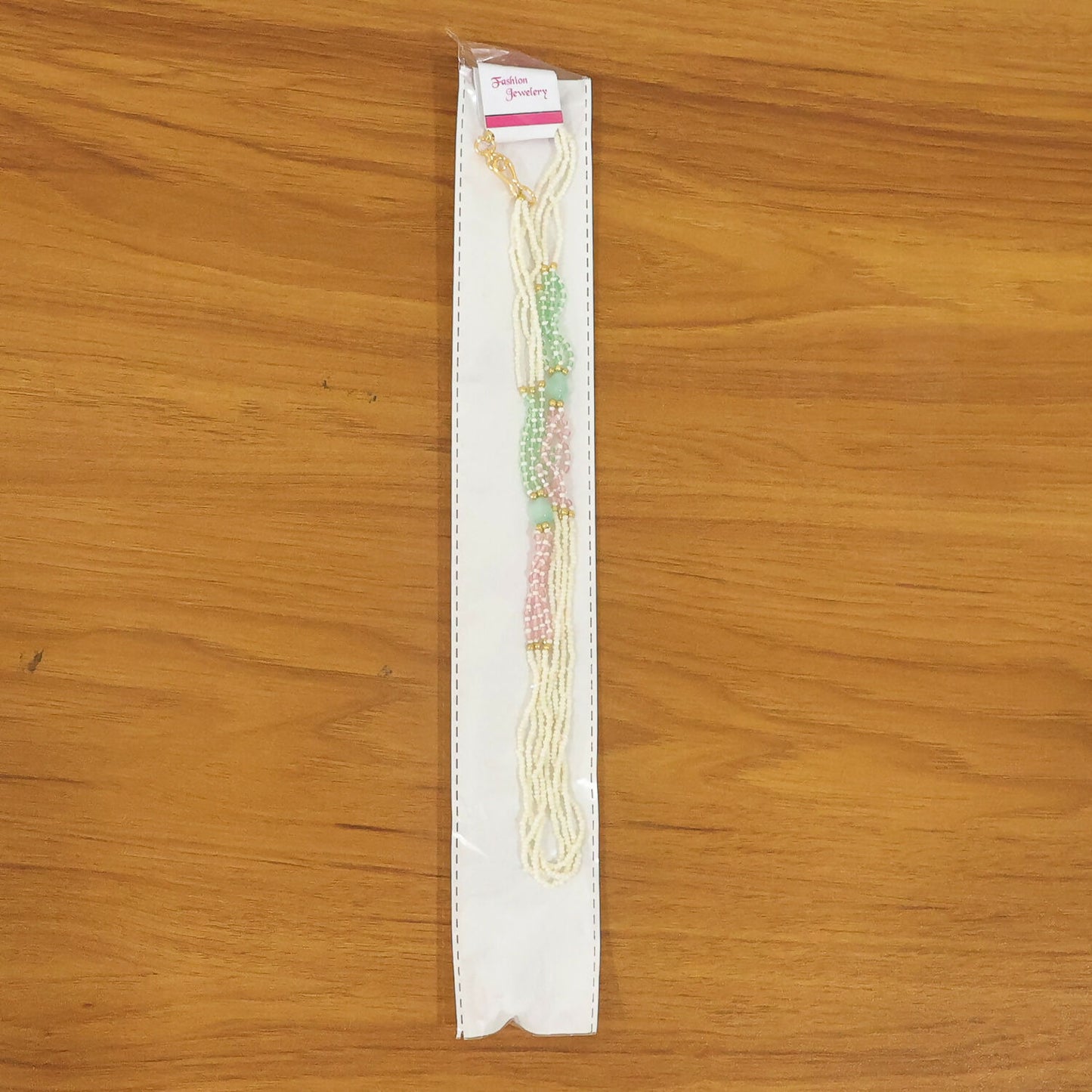 Handmade pearl mala necklace with pastel beads styled on display