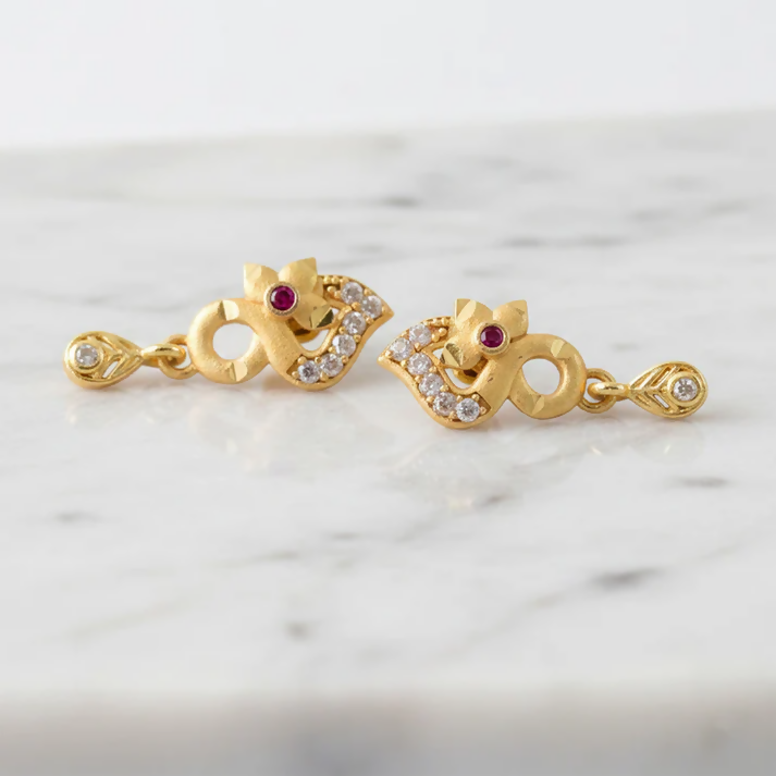 Gold plated earrings displayed on black background