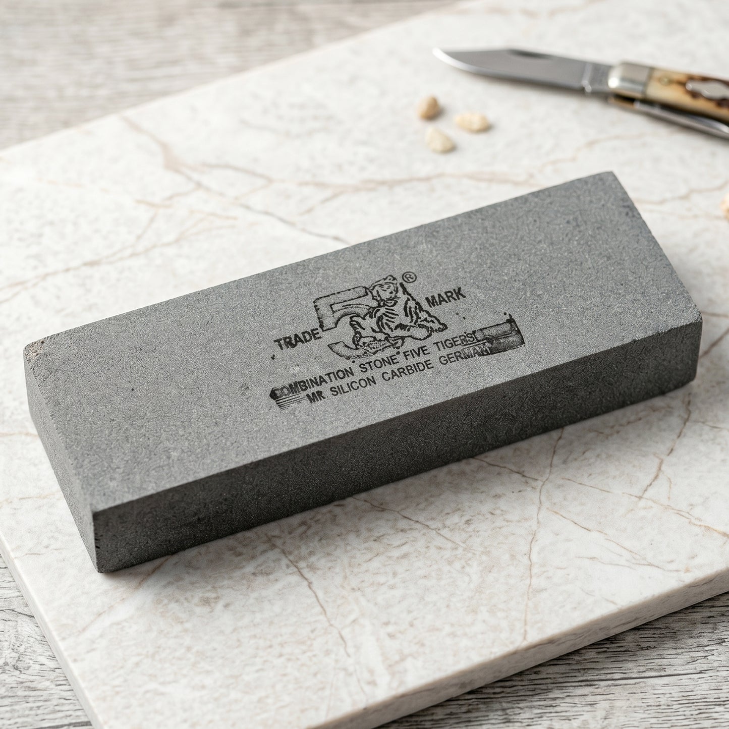 Silicon carbide sharpening stone with coarse and fine sides