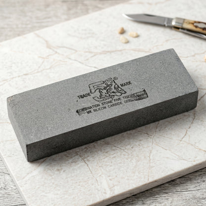 Silicon carbide sharpening stone with coarse and fine sides