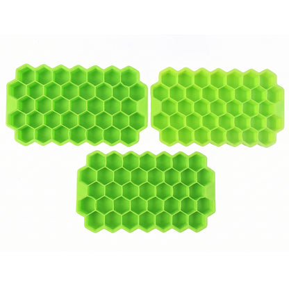 Three identical bright green silicone ice cube trays, each with a honeycomb pattern, are arranged on a plain white