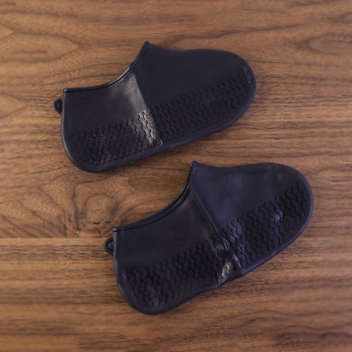 Black waterproof shoe cover displayed on white background