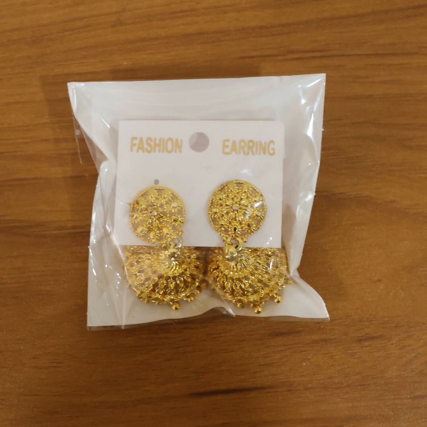 Elegant gold plated jhumka earrings highlighting ethnic design