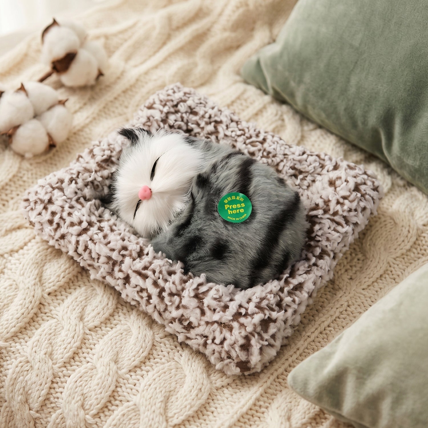 Soft plush cat open eye figurine on table