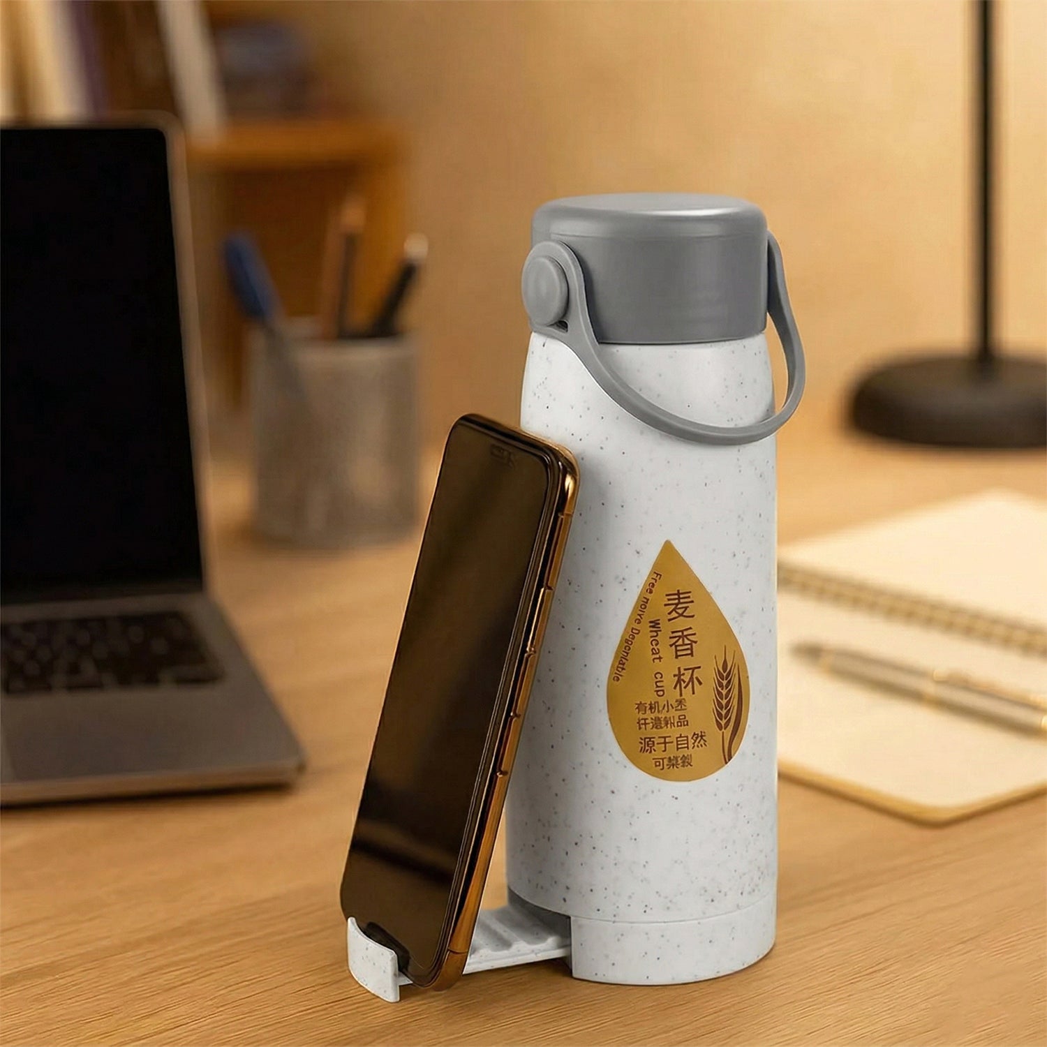 Leakproof glass water bottle showing phone holder feature