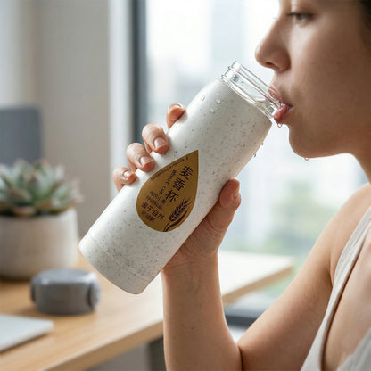 Office water bottle with built-in phone stand on desk
