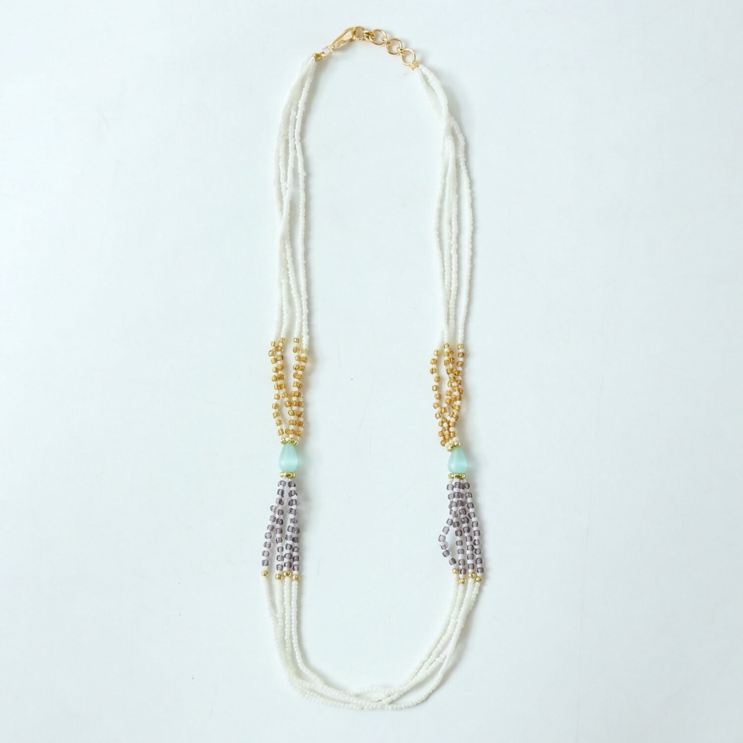 Pearl necklace with pastel lavender accents in soft light