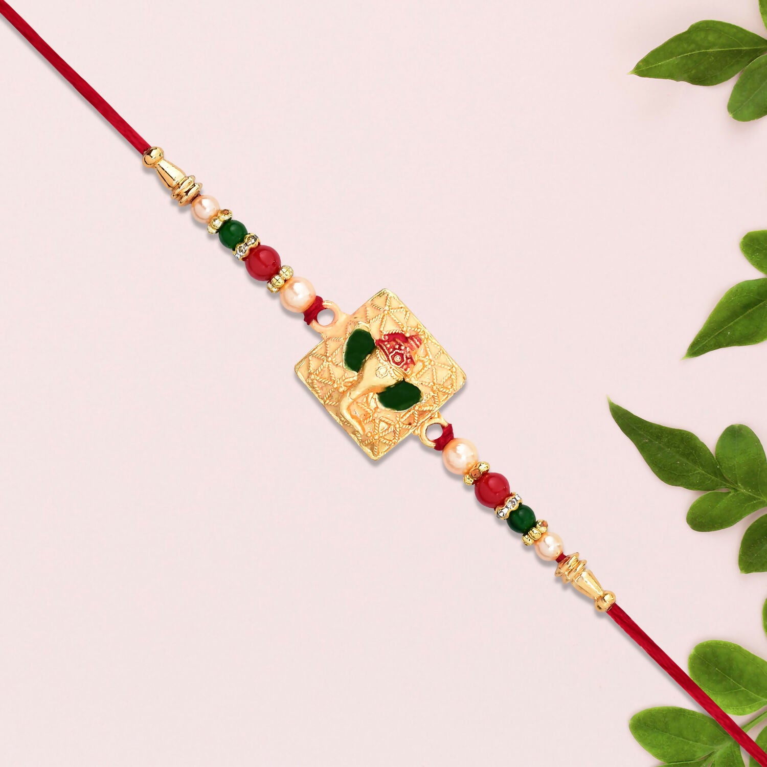 Close-up of Golden Ganpati Rakhi showing enamel detailing