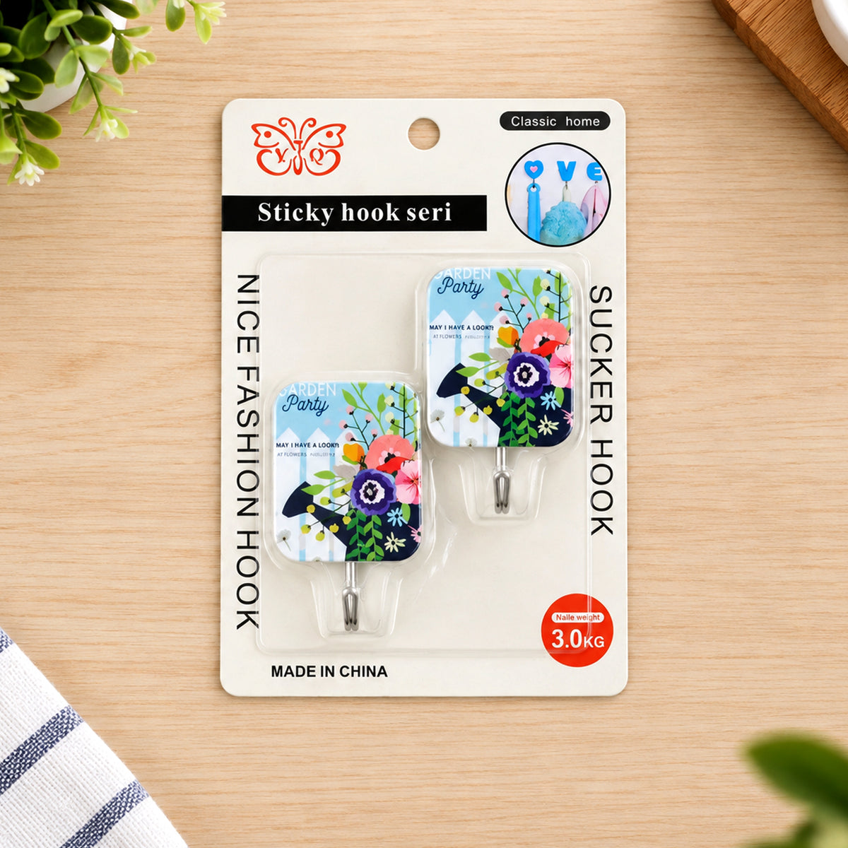 Two floral-patterned adhesive hooks in blister packaging, featuring a butterfly logo and 3.0KG weight capacity.