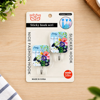 Two floral-patterned adhesive hooks in blister packaging, featuring a butterfly logo and 3.0KG weight capacity.