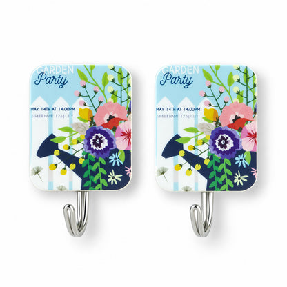 Pair of rectangular adhesive hooks with a vibrant garden party floral design and silver metal hooks.