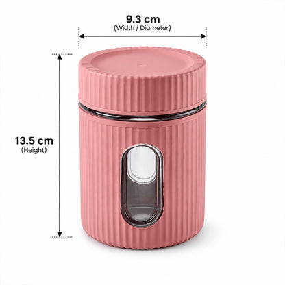 A pink ribbed storage jar with a clear window and lid displays its height and width measurements on a white backdrop.