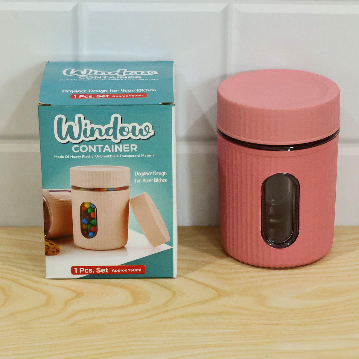 Pink ribbed storage jar with window on a wooden surface