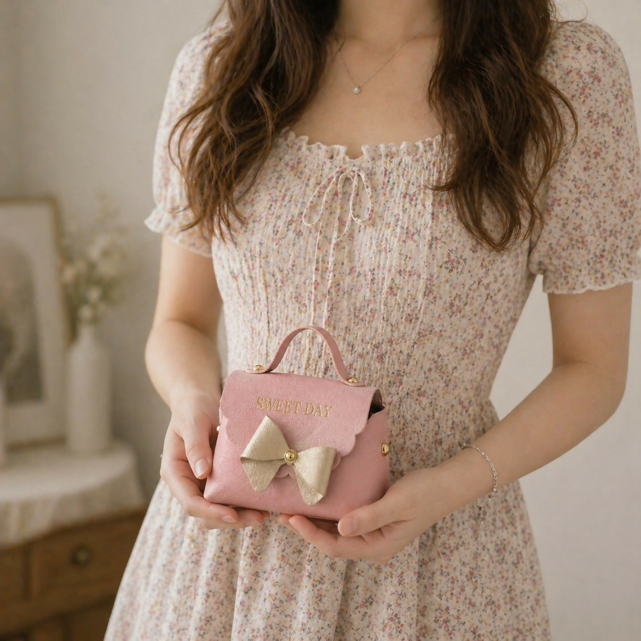 Pink mini handbag with bow design side view