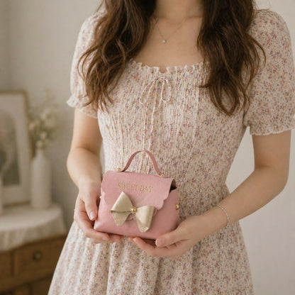 Pink mini handbag with bow design side view