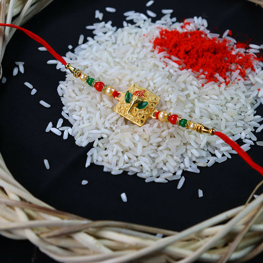 Golden Ganpati Rakhi with red and green beads