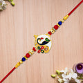 Ganesha Rakhi with Peacock Enamel Charm – Festive Elegance