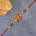 Bead Rakhi with Golden Flower Motif – Elegant & Festive Sibling Gift