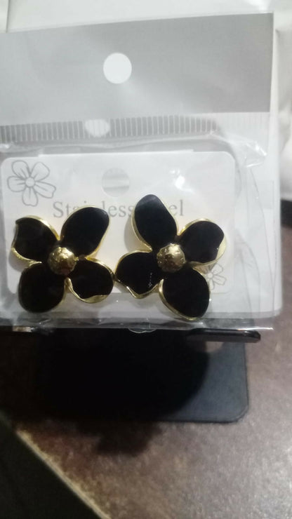 Model wearing black floral enamel stud earrings
