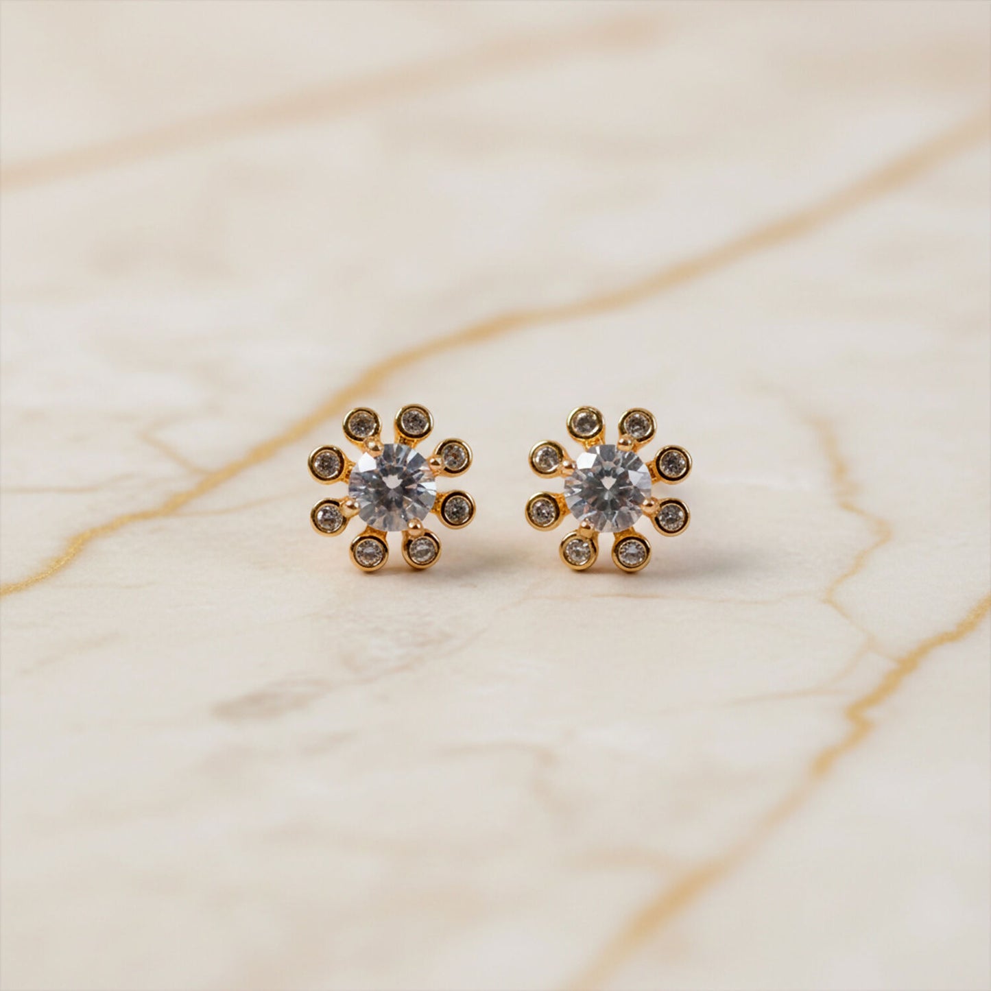 Side angle of gold finish flower design stone stud earrings for daily and party wear