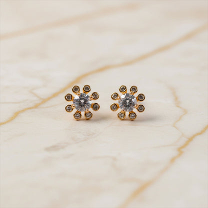 Side angle of gold finish flower design stone stud earrings for daily and party wear