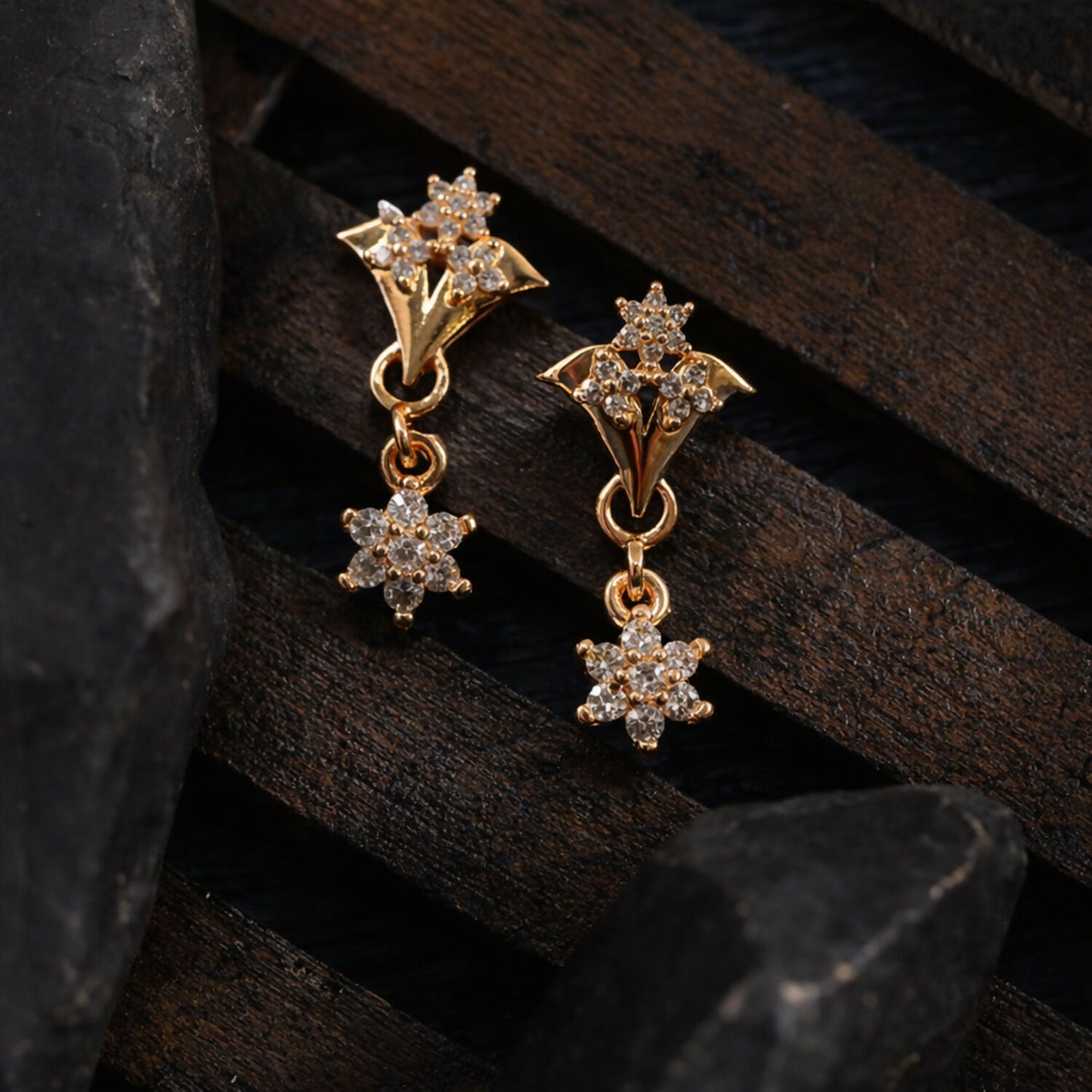 Star drop earrings styled with shimmering rose gold finish and crystals
