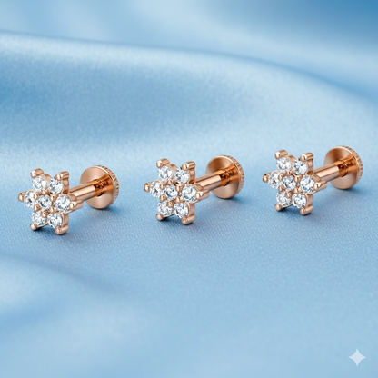 Close-up of rose gold floral studs with brilliant crystal detailing on each petal