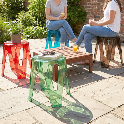 Transparent plastic stools neatly stacked to save space, ideal for compact homes.