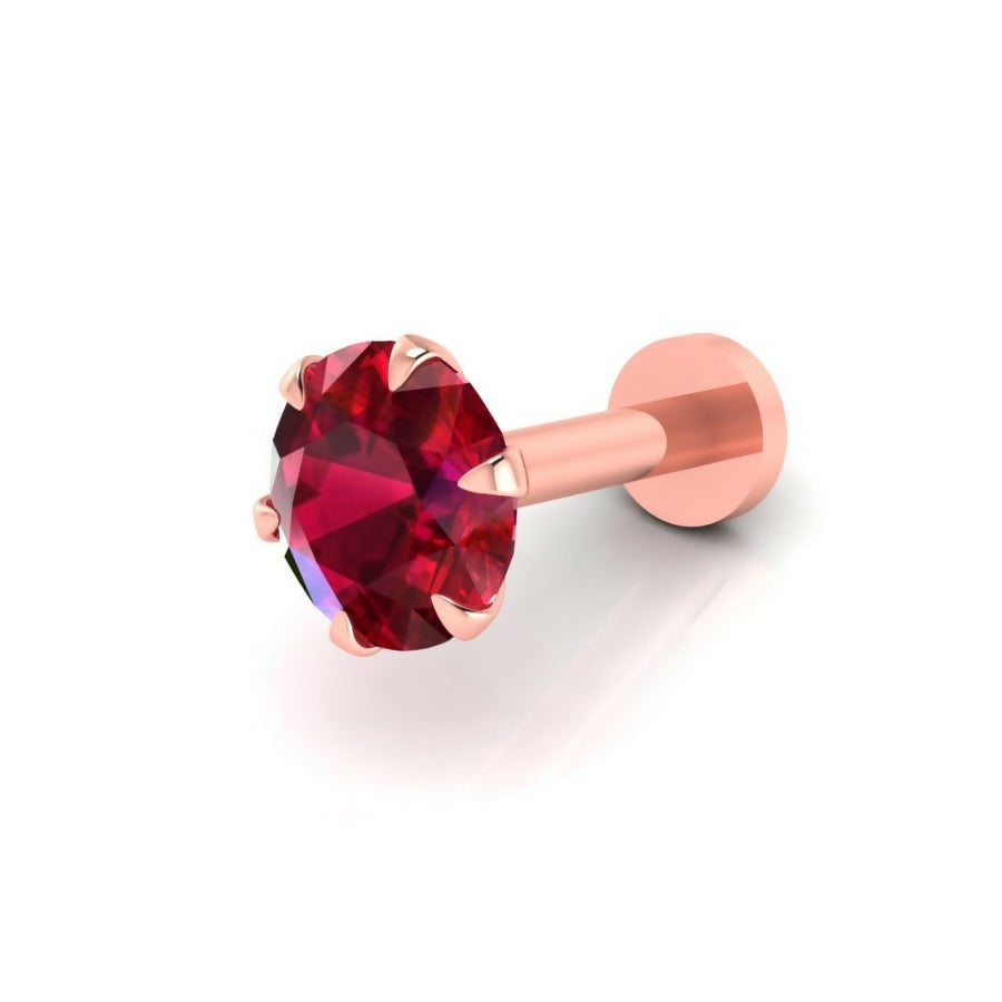 Close-up of radiant ruby red cubic zirconia in rose gold nosepin stud
