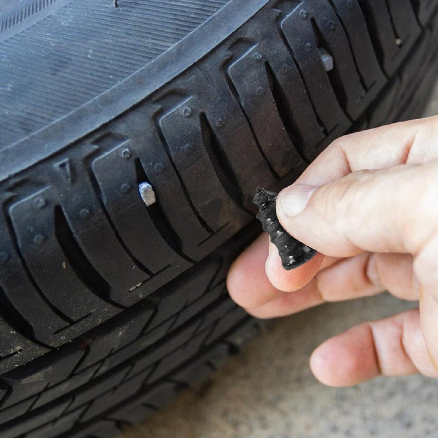 Close-up image of pink tire repair nail plug