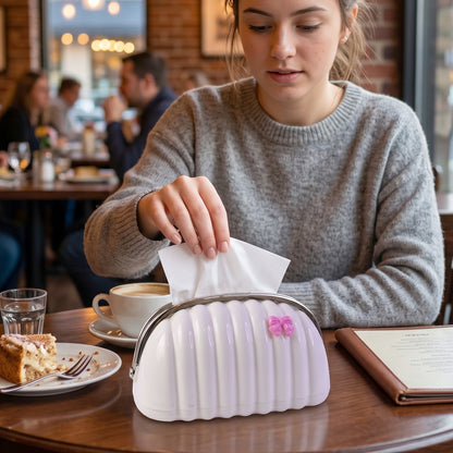 Handbag shaped tissue dispenser featuring a pink bow