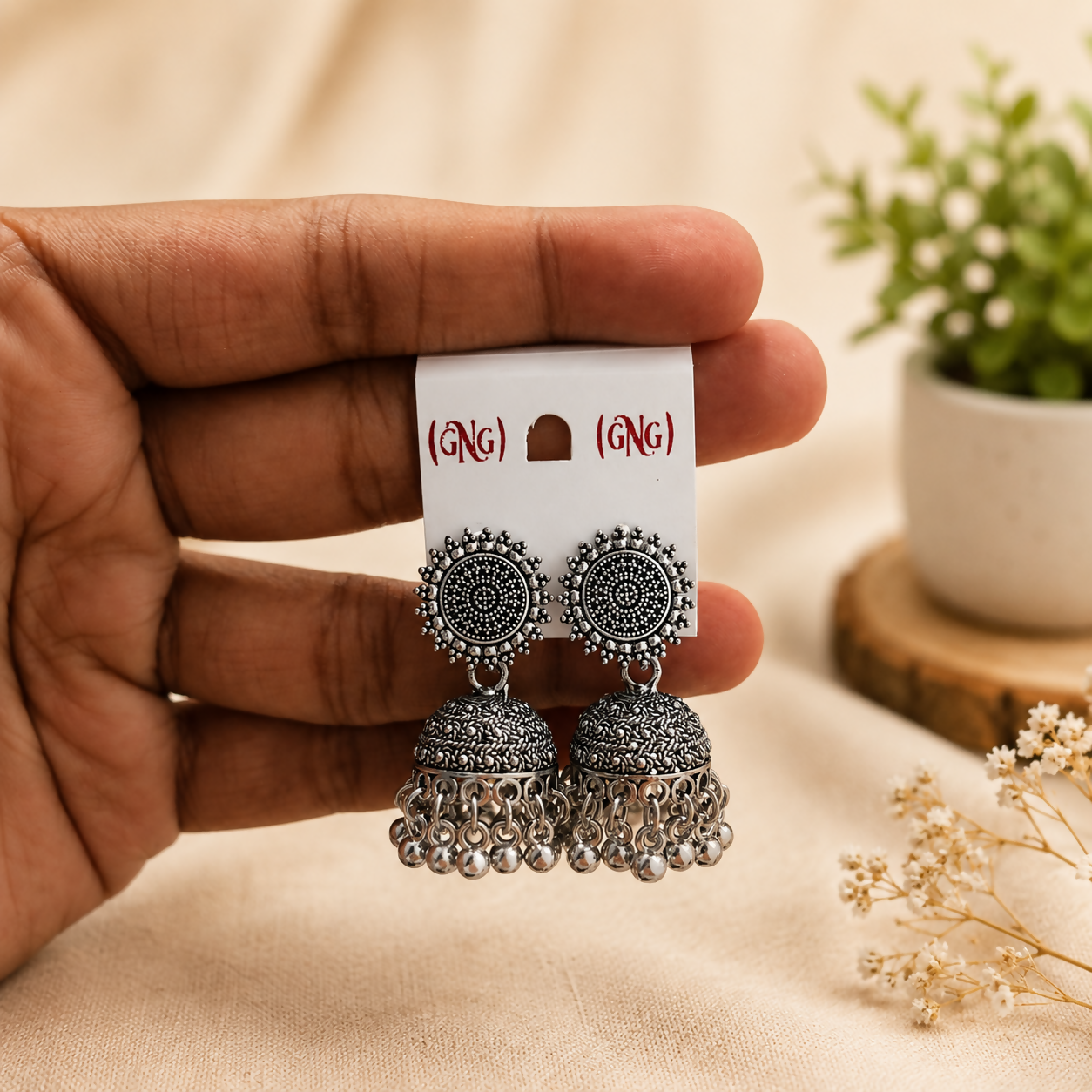 Close-up view of the traditional oxidised silver jhumka earrings showcasing detailed craftsmanship.