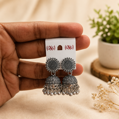Close-up view of the traditional oxidised silver jhumka earrings showcasing detailed craftsmanship.