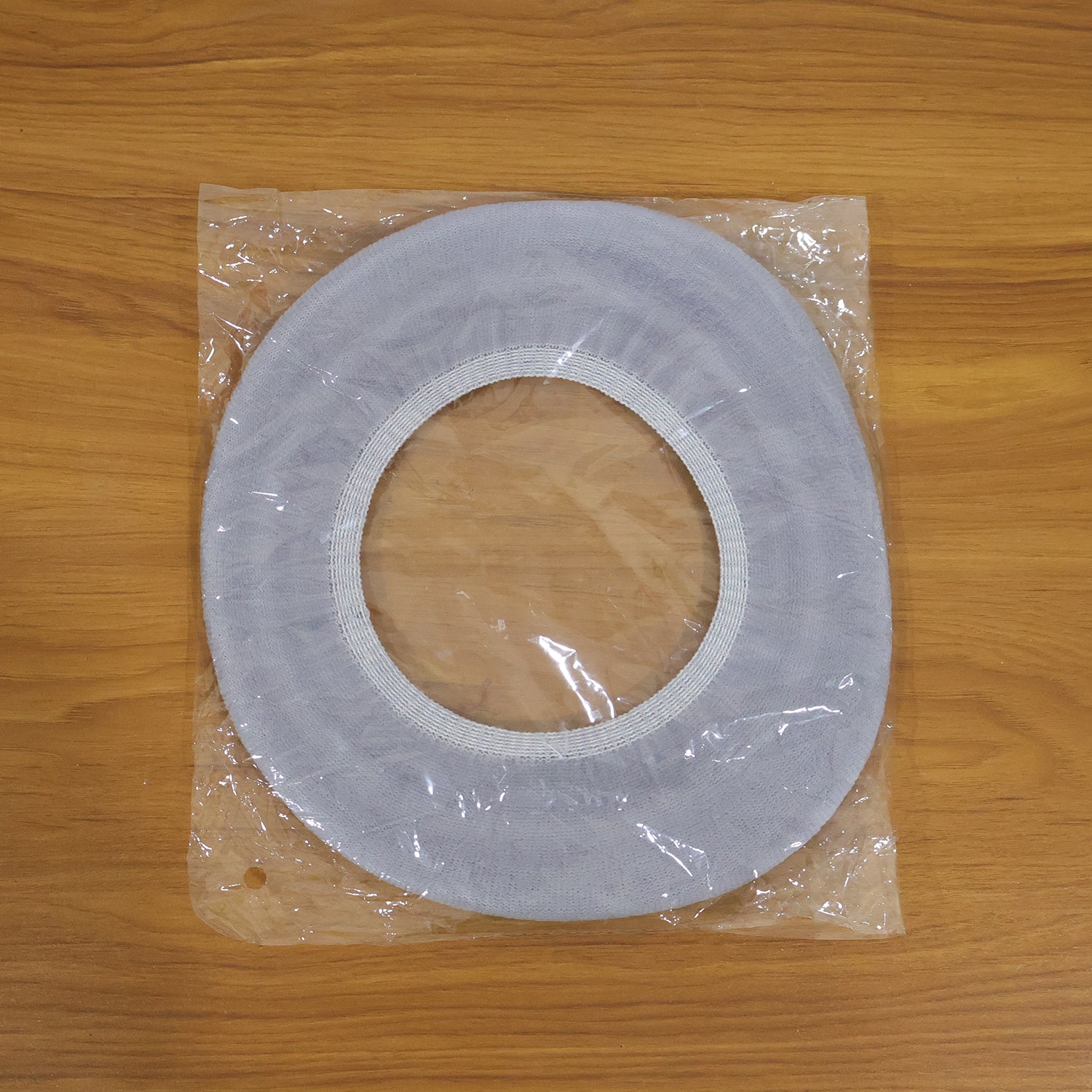 Soft fabric toilet seat cover in bathroom setting