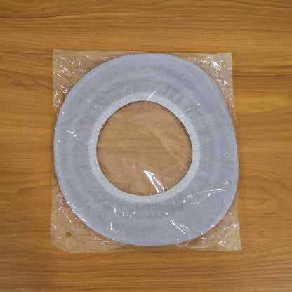 Soft fabric toilet seat cover in bathroom setting