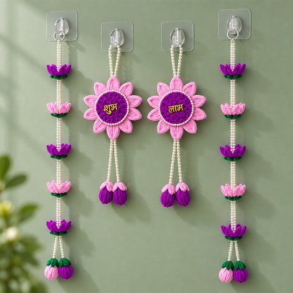 Four pink and purple lotus flower hangings with pearl beads displayed against a light green wall.