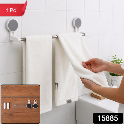 A person hangs a white towel on a silver self-adhesive towel rod in a white tiled bathroom, with a small inset image of