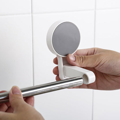 Hands demonstrate attaching the silver rod into one of the white circular end pieces against a white tiled background.